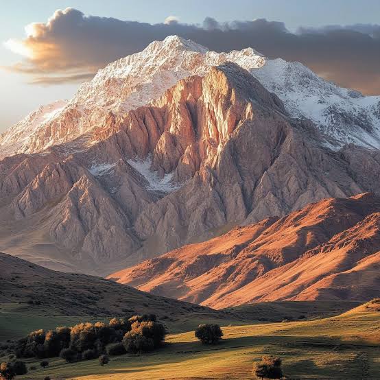 Warm light across the rugged ridges of the Dena mountains