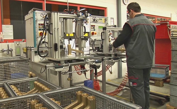 A worker operating industrial manufacturing equipment