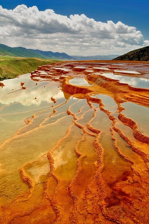 Warm mineral colors and flowing forms in an arid landscape