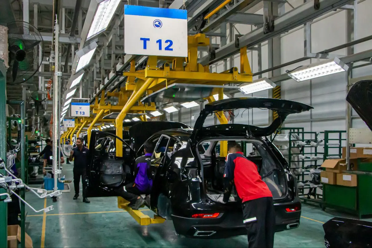 Vehicles moving through an automotive assembly line