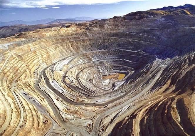 Terraced benches spiraling into an open-pit mine